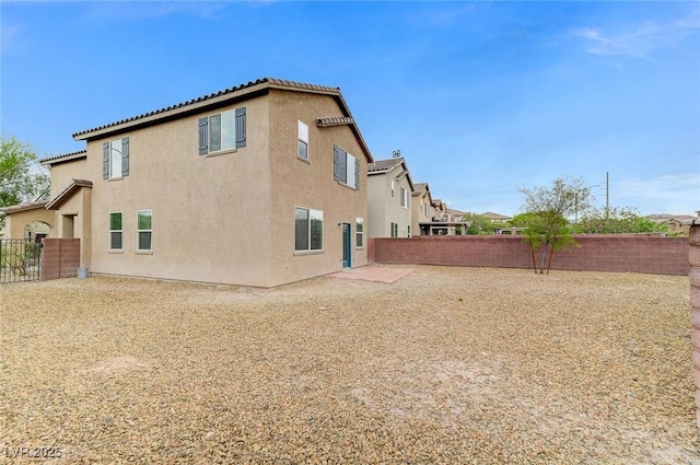 7534 Earnshaw Ave, Las Vegas, NV 89179 - rear view of property with a fenced backyard and stucco siding