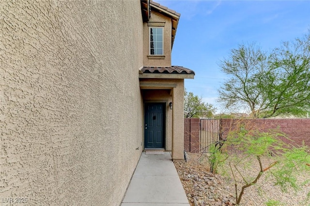 7534 Earnshaw Ave, Las Vegas, NV 89179 - property entrance featuring stucco siding and a tile roof
