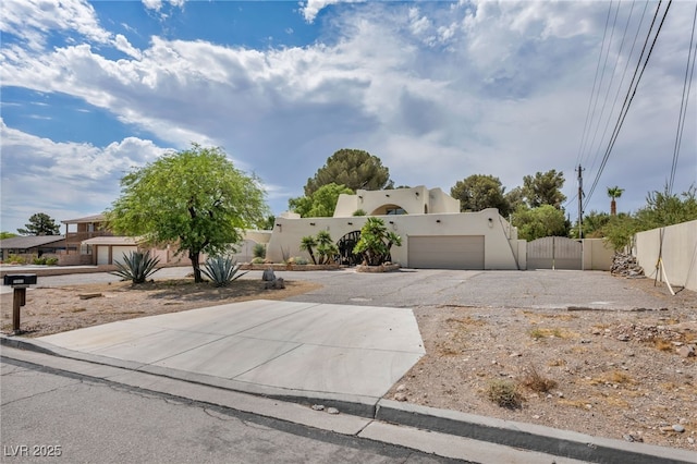 7045 Edna Ave, Las Vegas, NV 89117 - view of front of home with a gate, driveway, stucco siding, and a garage