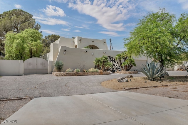 7045 Edna Ave, Las Vegas, NV 89117 - view of side of property featuring a gate, stucco siding, and driveway