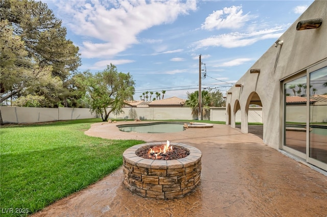 7045 Edna Ave, Las Vegas, NV 89117 - fenced backyard featuring an outdoor fire pit and a patio