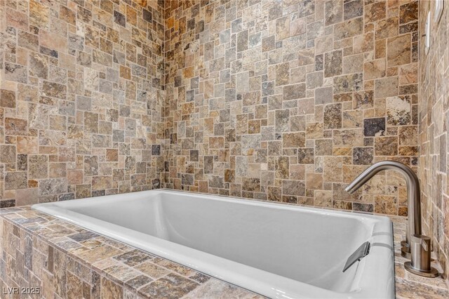 7045 Edna Ave, Las Vegas, NV 89117 - bathroom featuring tiled tub and tile walls