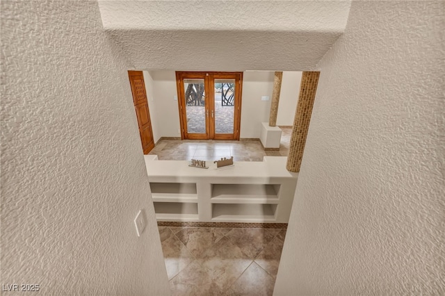 7045 Edna Ave, Las Vegas, NV 89117 - entrance foyer featuring a textured wall, french doors, tile patterned floors, and a textured ceiling