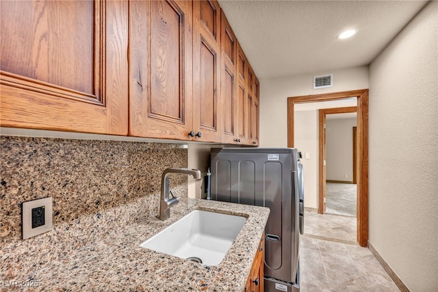 7045 Edna Ave, Las Vegas, NV 89117 - laundry room with cabinet space, washer / clothes dryer, recessed lighting, and a textured ceiling