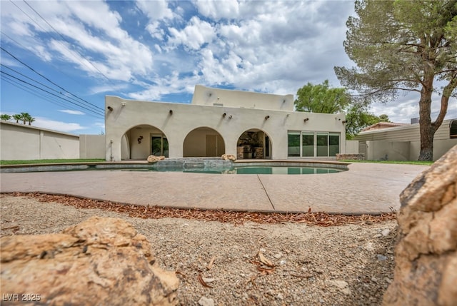 7045 Edna Ave, Las Vegas, NV 89117 - rear view of house with stucco siding and a patio area