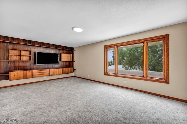 7045 Edna Ave, Las Vegas, NV 89117 - unfurnished living room featuring carpet flooring and wood walls