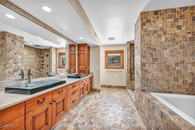 7045 Edna Ave, Las Vegas, NV 89117 - full bath with double vanity, tiled bath, stone finish flooring, recessed lighting, and tiled shower