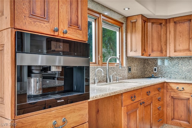 7045 Edna Ave, Las Vegas, NV 89117 - kitchen featuring brown cabinets, backsplash, light countertops, and black oven
