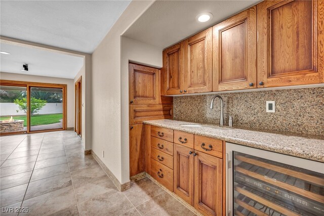7045 Edna Ave, Las Vegas, NV 89117 - kitchen with wine cooler, backsplash, and brown cabinets