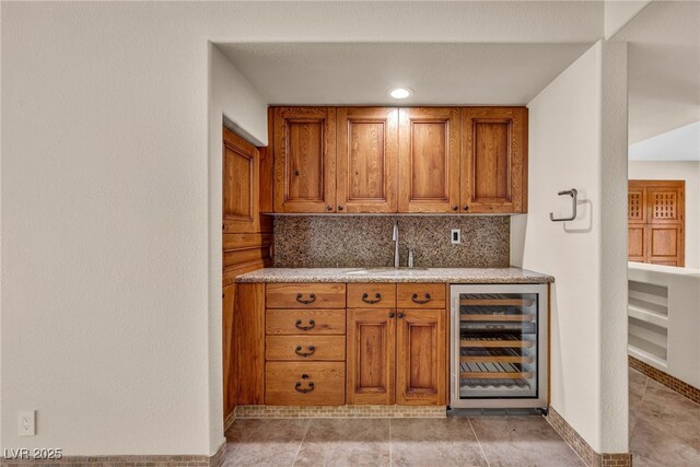 7045 Edna Ave, Las Vegas, NV 89117 - indoor wet bar featuring beverage cooler and decorative backsplash