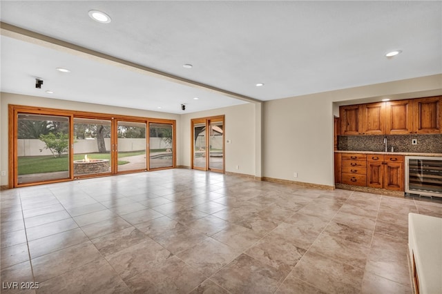 7045 Edna Ave, Las Vegas, NV 89117 - unfurnished living room with wine cooler, wet bar, and recessed lighting