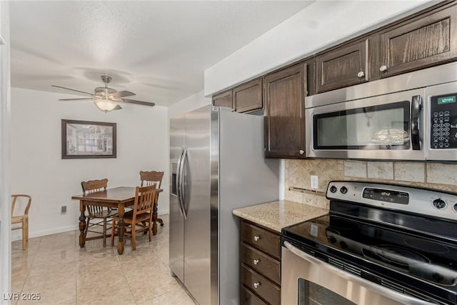 2725 S Nellis Blvd Unit 1037, Las Vegas, NV 89121 - kitchen featuring appliances with stainless steel finishes, dark brown cabinetry, backsplash, ceiling fan, and light stone countertops