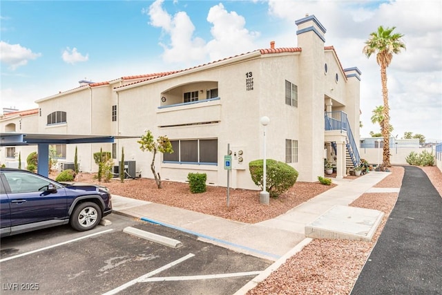 2725 S Nellis Blvd Unit 1037, Las Vegas, NV 89121 - view of property with uncovered parking and stairs