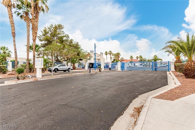 2725 S Nellis Blvd Unit 1037, Las Vegas, NV 89121 - view of asphalt road featuring a gate, curbs, and sidewalks
