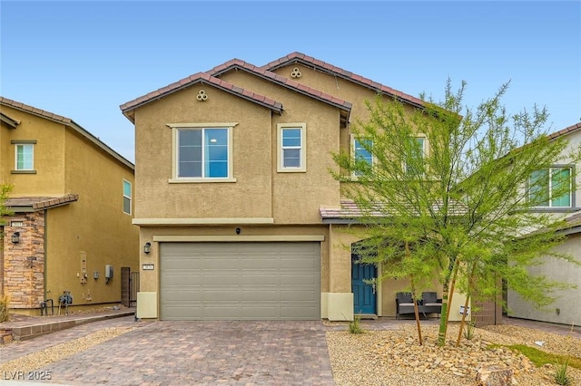 2821 Gaffer Film St, Las Vegas, NV 89156 - view of front of house featuring stucco siding, an attached garage, and decorative driveway