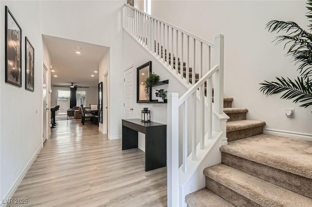 2821 Gaffer Film St, Las Vegas, NV 89156 - stairs featuring wood finished floors, recessed lighting, a ceiling fan, and a towering ceiling
