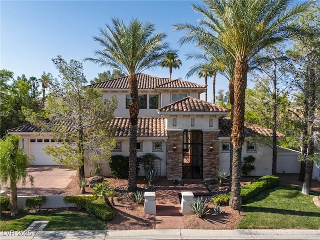 8712 Mesa Canogo Dr, Las Vegas, NV 89148 - mediterranean / spanish house featuring stucco siding, a tiled roof, driveway, a garage, and stone siding