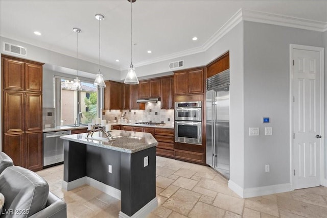 30 Via Mantova Unit 202, Henderson, NV 89011 - kitchen with stainless steel appliances, backsplash, under cabinet range hood, light stone countertops, and ornamental molding