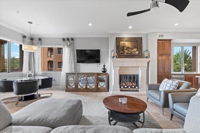 30 Via Mantova Unit 202, Henderson, NV 89011 - living area with a ceiling fan, a lit fireplace, recessed lighting, and crown molding