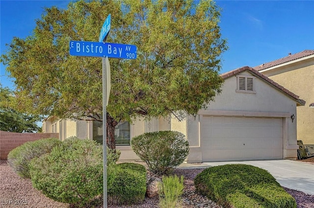 1213 Bistro Bay Ave, North Las Vegas, NV 89086 - view of front of property with an attached garage, driveway, stucco siding, and a tile roof