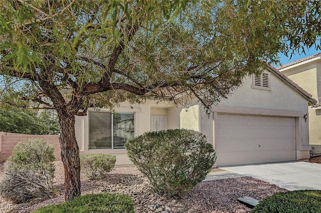 1213 Bistro Bay Ave, North Las Vegas, NV 89086 - view of property hidden behind natural elements with stucco siding, a garage, and driveway