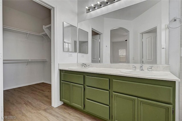 1213 Bistro Bay Ave, North Las Vegas, NV 89086 - bathroom featuring double vanity, wood finished floors, and a walk in closet