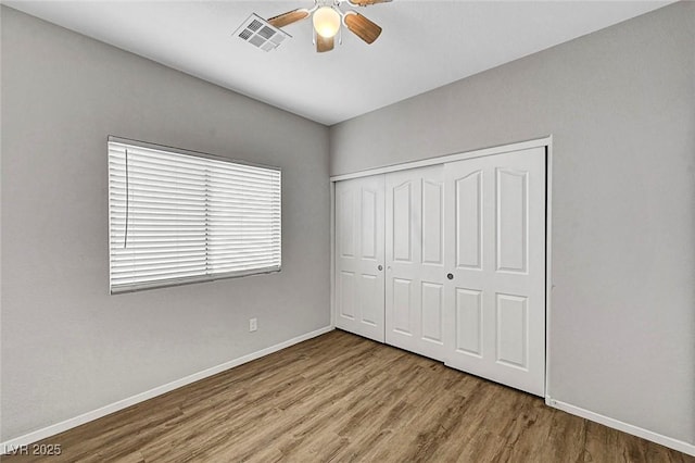 1213 Bistro Bay Ave, North Las Vegas, NV 89086 - unfurnished bedroom with wood finished floors, a closet, and ceiling fan