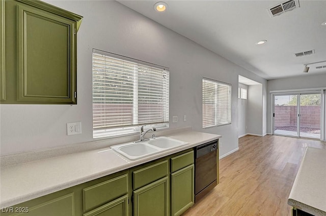 1213 Bistro Bay Ave, North Las Vegas, NV 89086 - kitchen featuring green cabinets, dishwashing machine, light wood-type flooring, light countertops, and recessed lighting