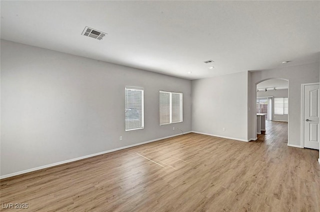 1213 Bistro Bay Ave, North Las Vegas, NV 89086 - unfurnished room with arched walkways and light wood-style floors