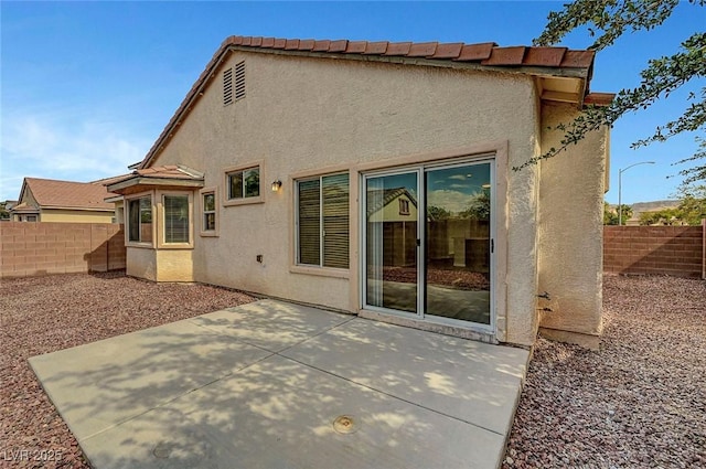 1213 Bistro Bay Ave, North Las Vegas, NV 89086 - rear view of house with stucco siding, a fenced backyard, and a patio