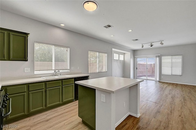 1213 Bistro Bay Ave, North Las Vegas, NV 89086 - kitchen featuring green cabinetry, dishwashing machine, stove, light countertops, and recessed lighting