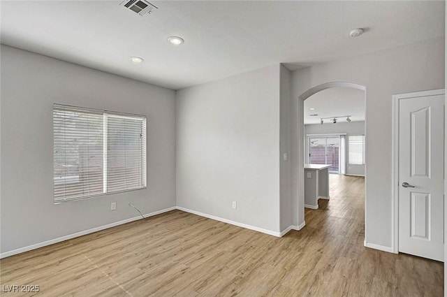 1213 Bistro Bay Ave, North Las Vegas, NV 89086 - spare room with arched walkways, light wood-type flooring, a smoke detector, and recessed lighting