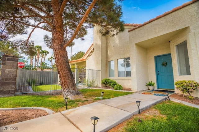 2251 Vangogh Dr, Henderson, NV 89074 - property entrance with stucco siding and a tiled roof