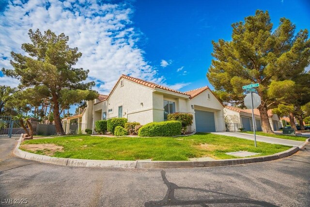 2251 Vangogh Dr, Henderson, NV 89074 - mediterranean / spanish house with a tiled roof, stucco siding, concrete driveway, and a garage