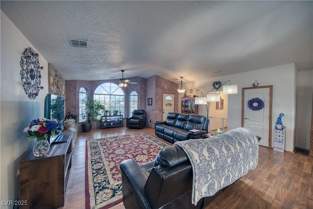 2910 Sunset St, Pahrump, NV 89060 - living room with lofted ceiling, a ceiling fan, wood finished floors, and a textured ceiling