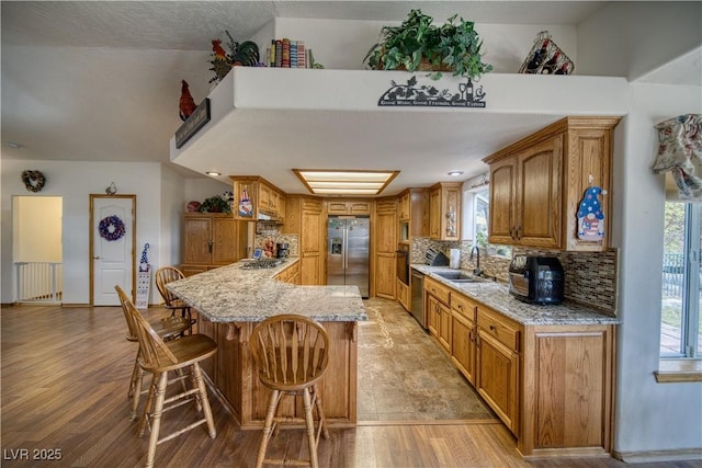 2910 Sunset St, Pahrump, NV 89060 - kitchen featuring appliances with stainless steel finishes, a kitchen bar, healthy amount of natural light, and light stone countertops