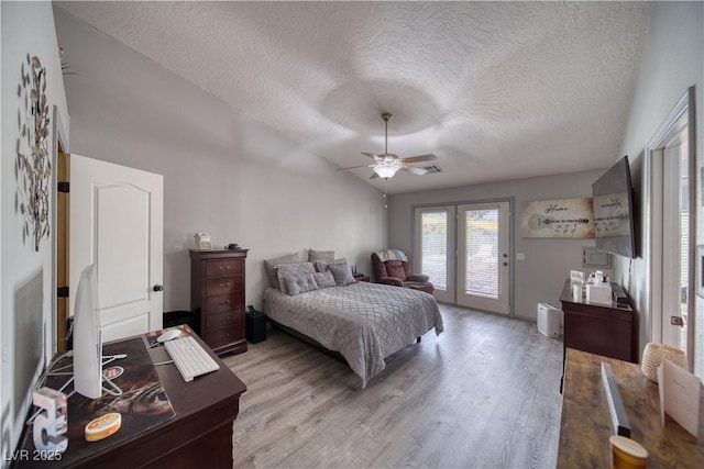 2910 Sunset St, Pahrump, NV 89060 - bedroom with access to outside, a textured ceiling, light wood-style flooring, lofted ceiling, and ceiling fan