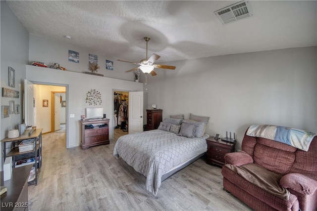 2910 Sunset St, Pahrump, NV 89060 - bedroom with light wood finished floors, a spacious closet, a closet, a towering ceiling, and a textured ceiling