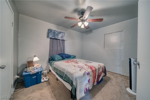 2910 Sunset St, Pahrump, NV 89060 - carpeted bedroom with concrete block wall and ceiling fan