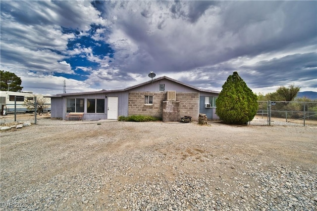 2910 Sunset St, Pahrump, NV 89060 - back of house featuring a sunroom and a gate