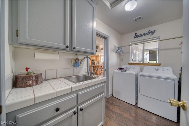 2910 Sunset St, Pahrump, NV 89060 - laundry room with cabinet space, washer and clothes dryer, and dark wood-style floors