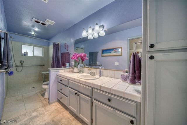 2910 Sunset St, Pahrump, NV 89060 - full bathroom featuring vanity, tiled shower, and tile patterned floors