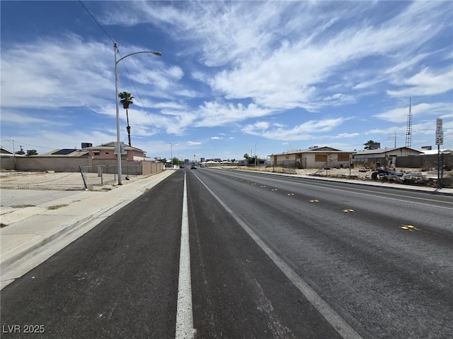 2212 Revere St, North Las Vegas, NV 89030 - view of asphalt street featuring street lighting, sidewalks, and curbs