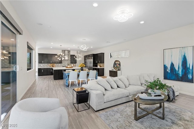 6234 Amber View St, Las Vegas, NV 89135 - living area featuring a chandelier, recessed lighting, and light wood-style flooring
