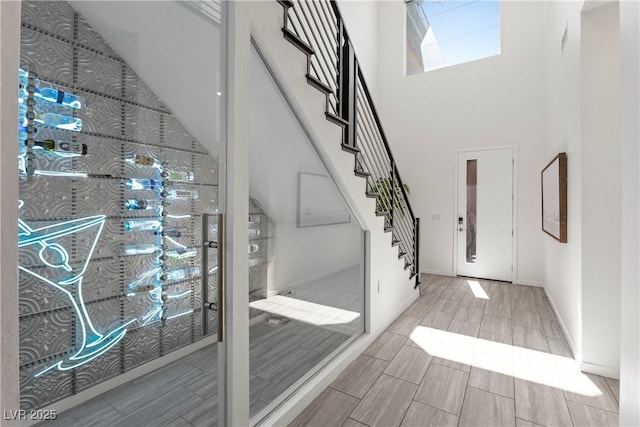 6234 Amber View St, Las Vegas, NV 89135 - foyer entrance with a high ceiling, stairs, and wood finish floors