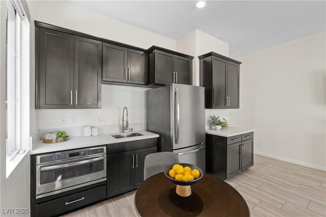 6234 Amber View St, Las Vegas, NV 89135 - kitchen featuring stainless steel appliances, light wood-style floors, light countertops, and recessed lighting