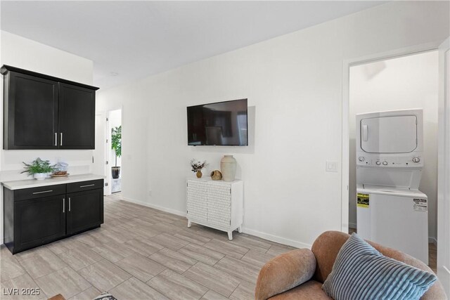 6234 Amber View St, Las Vegas, NV 89135 - living area featuring stacked washer / drying machine and baseboards
