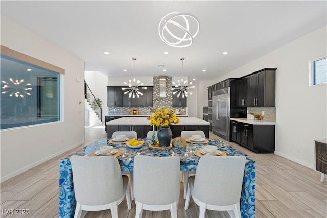 6234 Amber View St, Las Vegas, NV 89135 - dining room featuring a chandelier, recessed lighting, stairs, and light wood finished floors