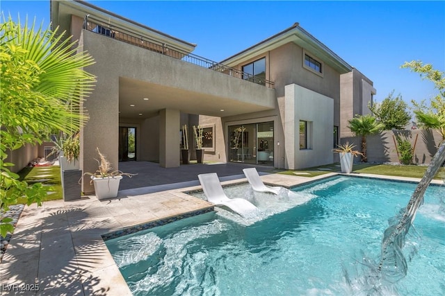 6234 Amber View St, Las Vegas, NV 89135 - back of house featuring a balcony, stucco siding, and a patio area