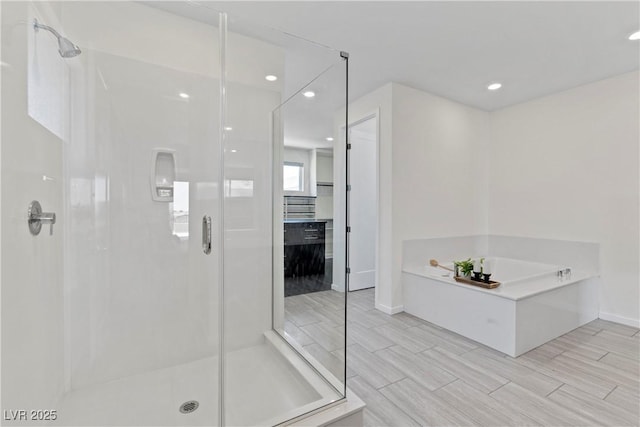 6234 Amber View St, Las Vegas, NV 89135 - full bathroom with a stall shower, a garden tub, recessed lighting, and wood finish floors